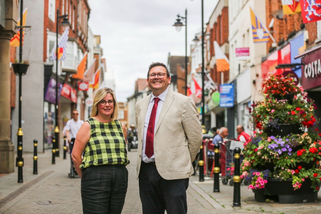 Two people stood in Evesham High Street facing the camera