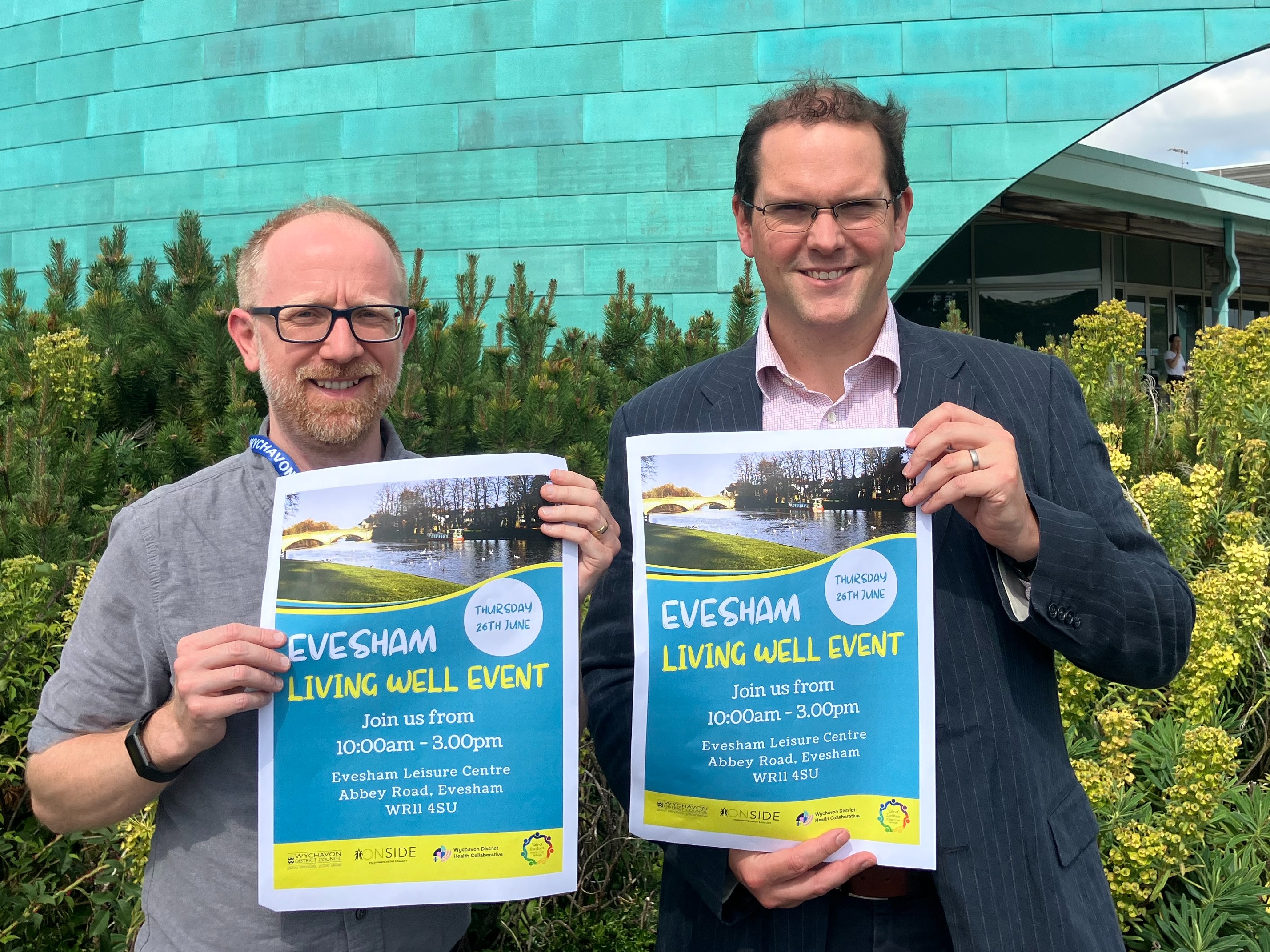 Two men holding posters