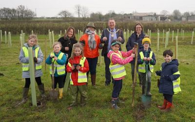 Chairman joins pupils to help plant new woodland