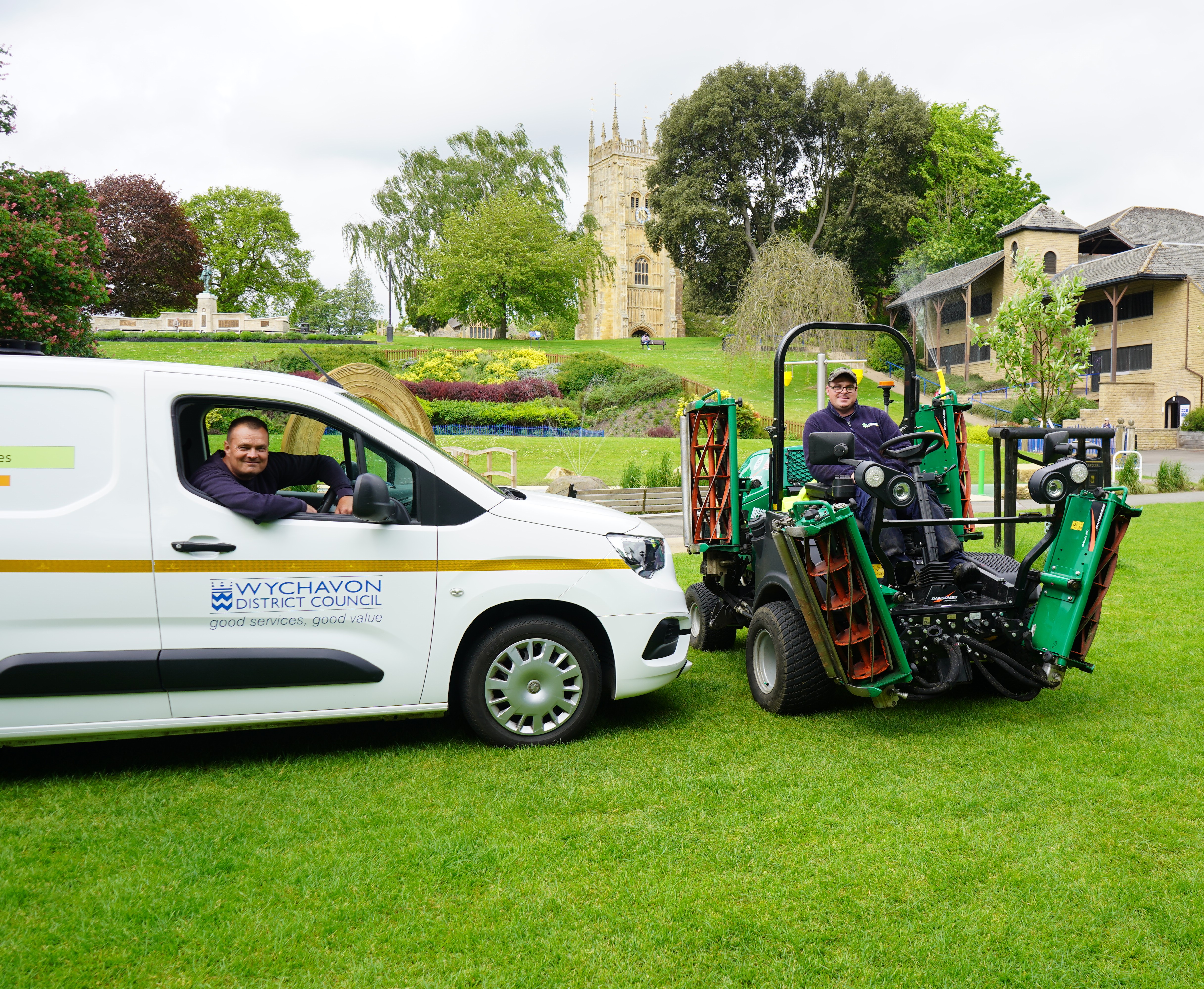 A man sat in van and a man sat on a mower.