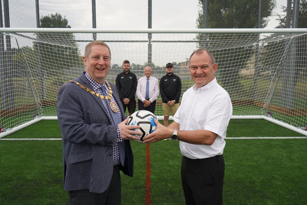 James Cox, Facilities Manager at Pershore High School helps Cllr Robert Raphael, Chairman of Wychavon District Council, Cllr Rob Adams, Executive Board Member for Stronger Communities, Culture and Sport on Wychavon District Council and players from The Talbot FC open the new 3G pitch.