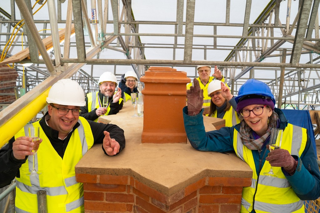 Six people stood around a chimney