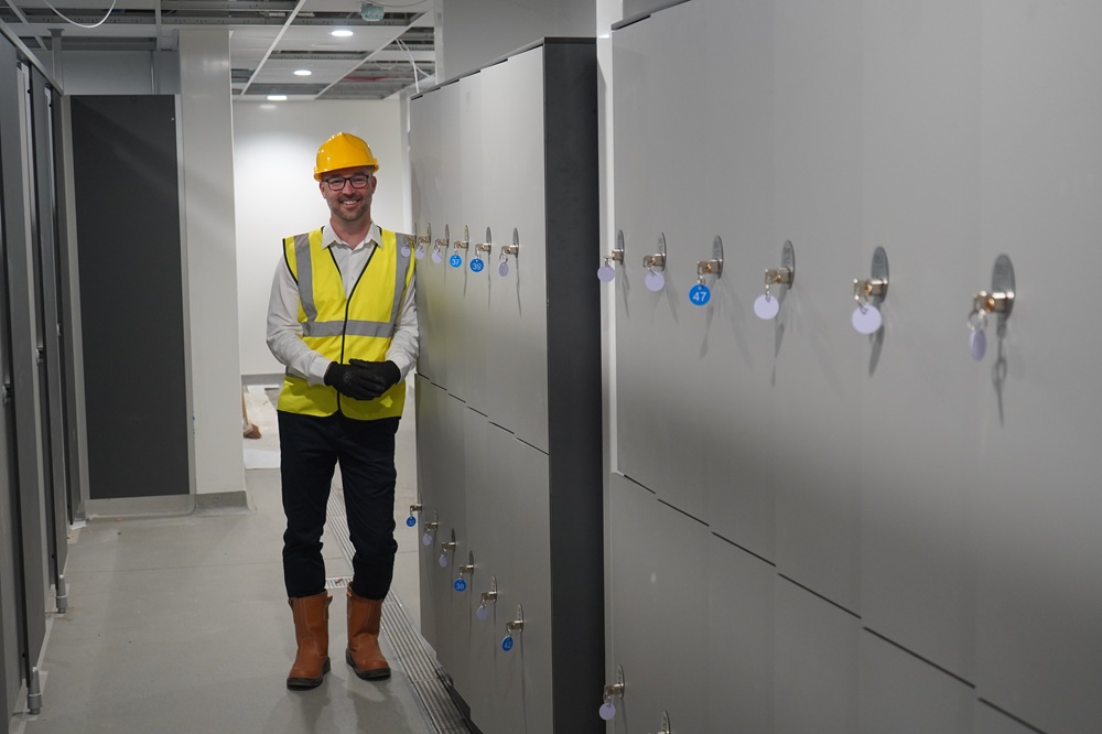 A man leaning on some lockers