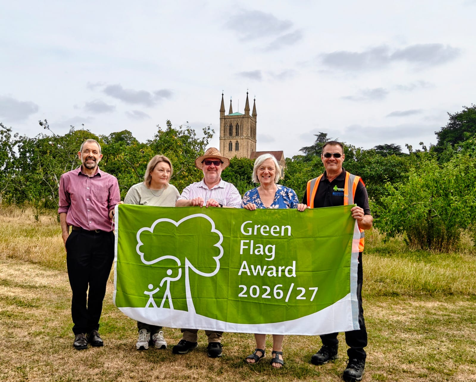 Five people stood behind a Green Flag Award 2026 flag in Pershore's Abbey Park