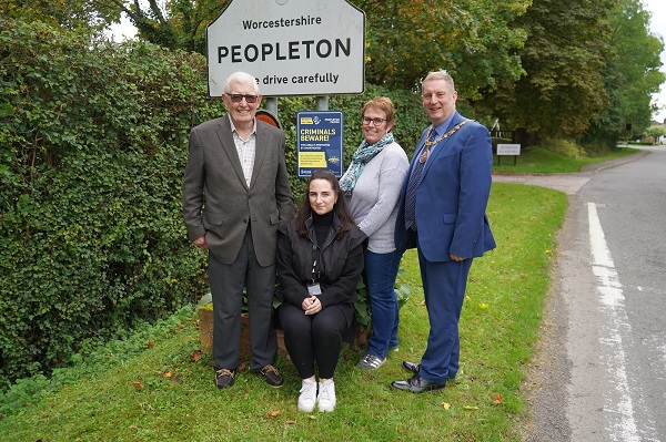 A group of people in front of a SmartWater sign.