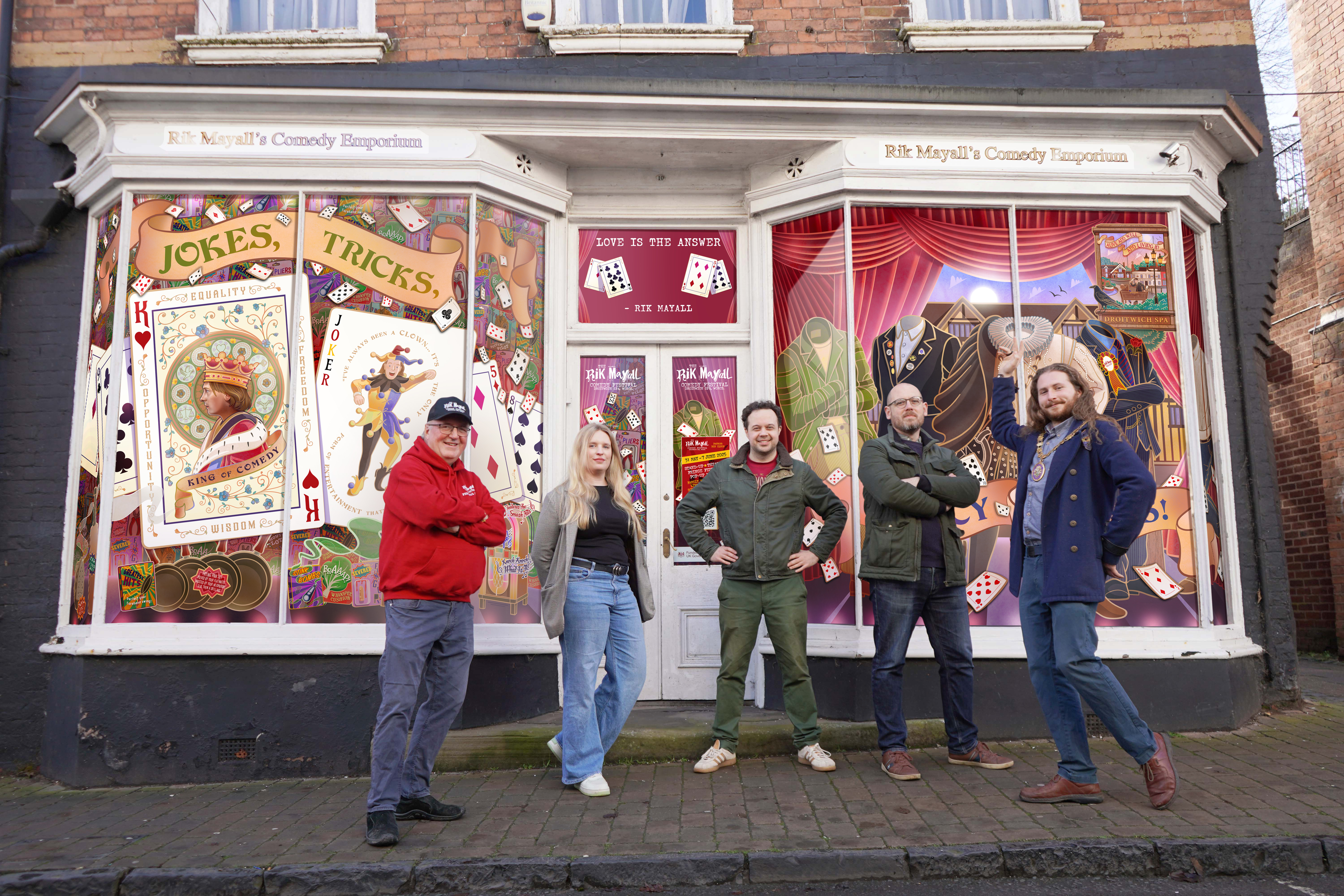 A group of people stood in front of a shop window