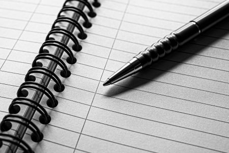 Lined notepad with ballpoint pen