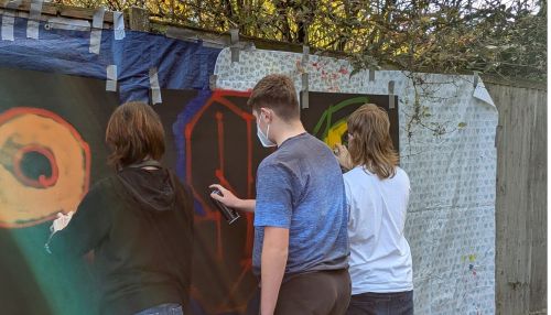 Young people creating street art